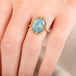 A model wears a handmade aquamarine gemstone and 18k yellow gold ring.
