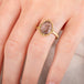 A model wears a handmade 18k yellow gold and super 7 gemstone ring.