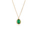 Gold necklace with a petite emerald gemstone set in a handmade gold bezel on a white background.