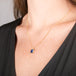 Necklace with a tanzanite gemstone set in a handmade gold bezel on a