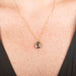 Handmade necklace featuring a watermelon tourmaline gemstone set in a 18k gold bezel on a person
