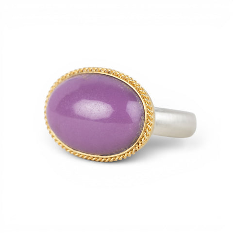 A gold and silver ring featuring a phosphosiderite stone, shown against a white background.