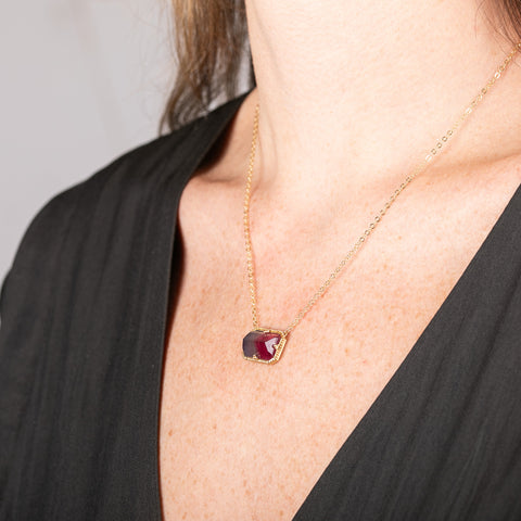 Necklace with a watermelon tourmaline gemstone pendant on a person