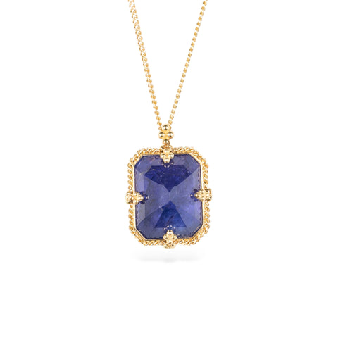 Handmade gold necklace with a blue tanzanite gemstone pendant on a white background