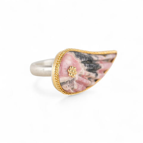 Carved rhodochrosite wing ring with a gold setting and silver band