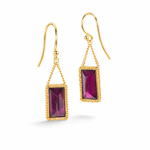 Gold earrings featuring rhodolite garnet gemstones shown against a white background.
