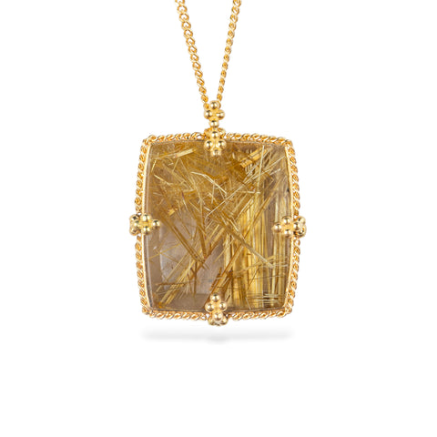 A gold pendant necklace featuring a rutilated quartz gemstone filled with fine metallic gold needles, suspended from a delicate gold chain against a white background.