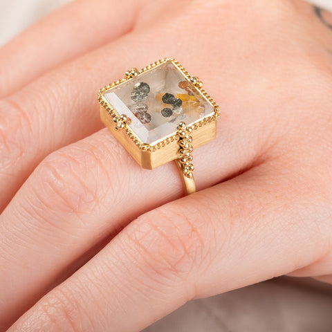 A model wears a unique quartz and 18k gold ring.