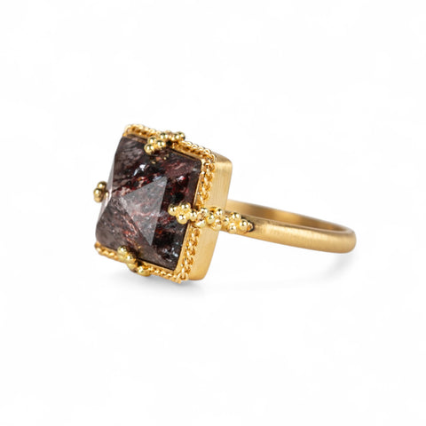 Gold ring with a square Super 7 gemstone on a white background.