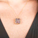 Handmade gold necklace with a Super 7 gemstone on a person