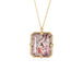 Handmade gold necklace with a Super 7 gemstone on a white background