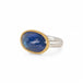 Handmade ring with blue tanzanite, gold bezel and sterling silver band on a white background