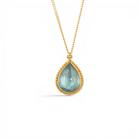 A gold necklace featuring a teardrop-shaped aquamarine necklace, shown against a white background.