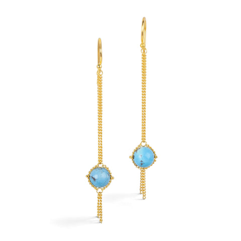 A pair of gold earrings featuring golden hills turquoise gemstones, shown against a white background.