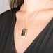 Handmade 18k yellow gold necklace with a tourmalated quartz pendant on a person