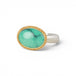 An oval ring featuring a green variscite stone with a natural matrix, set in a gold bezel with a sterling silver band on a white background