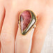 Ring with a teardrop-shaped watermelon tourmaline gemstone in a gold bezel with a sterling silver band