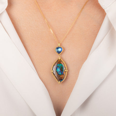 Gold Necklace featuring yowah nut opal and moonstone gemstones worn on a model's neck.