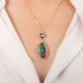 Gold Necklace featuring yowah nut opal and moonstone gemstones worn on a model's neck.