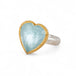 Heart-shaped ring with aquamarine stone, gold bezel and silver band on a white background