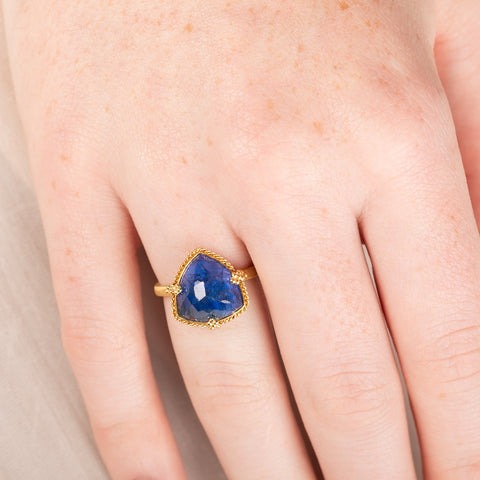 Gold ring with a tanzanite gemstone on a hand
