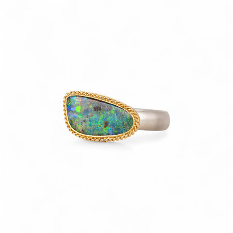 Boulder opal ring with gold bezel and sterling silver band