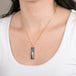 Boulder opal necklace with a handcrafted gold setting on a person