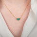 18k gold necklace featuring a boulder opal gemstone on a person