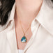 18k gold necklace with a boulder opal gemstone on a person