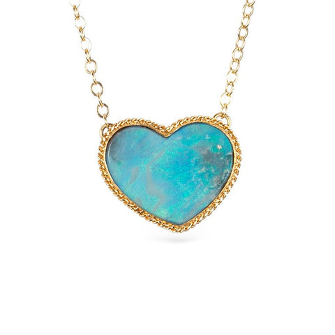 Necklace with a heart-shaped boulder opal stone pendant on a gold chain against a white background