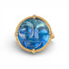 Gold ring with a carved face moonstone gemstone on a white background