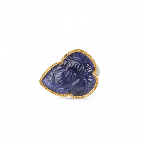 Handmade fine jewelry ring with carved tanzanite stone set in gold and complete with sterling silver band