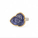 Handmade fine jewelry ring with carved tanzanite stone set in gold and complete with sterling silver band