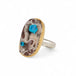 Handcrafted ring with a cavansite quartz gemstone, 18k gold bezel and sterling silver band on a white background