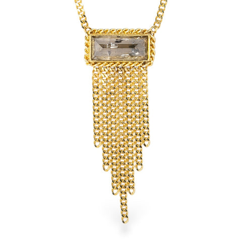 Gold necklace with a rectangular diamond and gold fringe on a white background