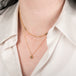 Gold necklace with a natural-colored diamond on a person