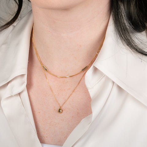 Handmade gold necklace with a natural-colored diamond on a person