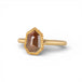 Gold ring with a brown diamond on a white background