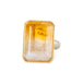 Ring with a bicolor citrine stone, gold setting and silver band on a white background