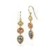 Gold earrings with three different colored diamonds on a white background