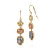 Gold earrings with three different colored diamonds on a white background