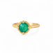 Gold ring with an emerald gemstone on a white background