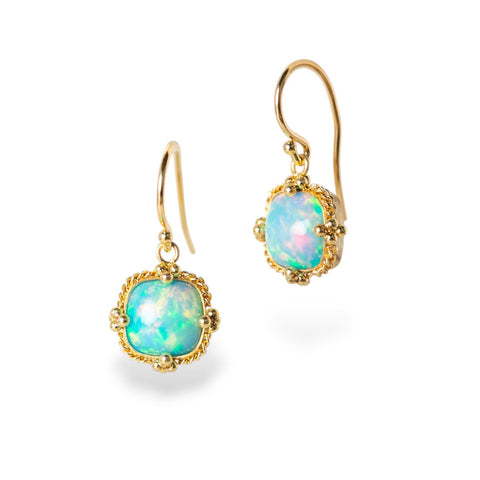 Gold earrings with Ethiopian opals on a white background