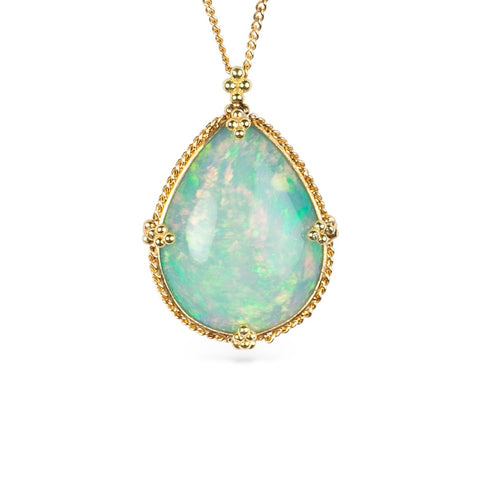 Ethiopian opal teardrop pendant necklace with gold setting on a white background