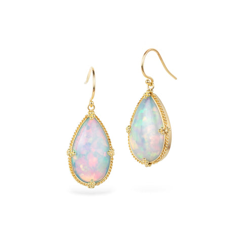 Opal earrings with gold frames on a white background
