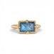 Gold ring with a blue moonstone on a white background