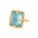 Gold ring with a large aquamarine gemstone on a white background
