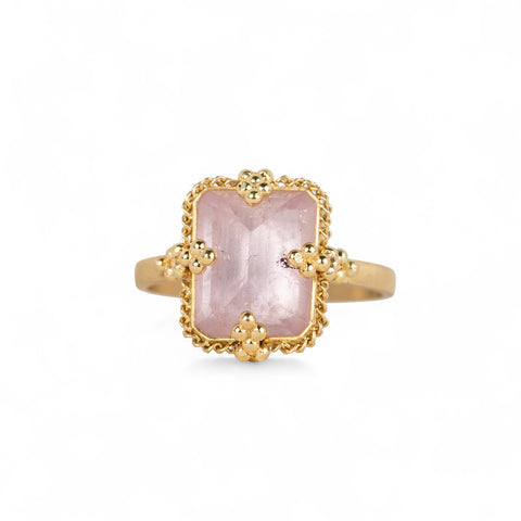 Gold ring with a morganite stone on a white background