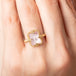 Gold ring with a morganite stone on a person's finger