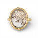 Gold ring with a dendritic quartz stone on a white background